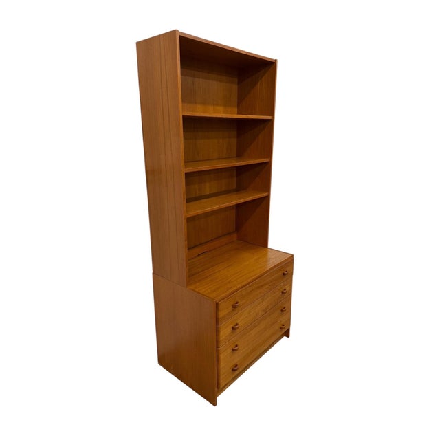 Vintage Danish Modern Domino Møbler 2-Piece Teak Bookcase, circa 1970s, expertly crafted in Denmark. This versatile...
