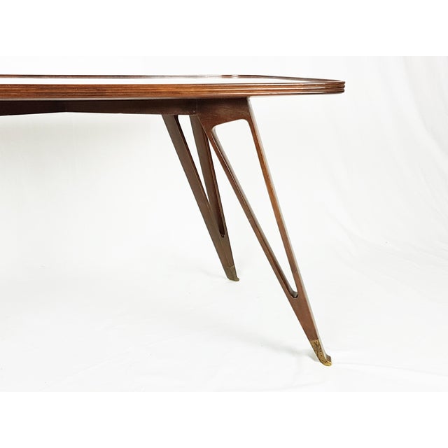 Elegant low wooden table with 4 open structure-legs and brass ends. Very good condition: partially restored. Brass...