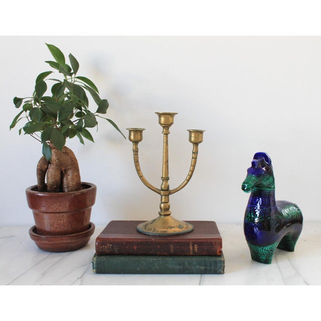 Vintage brass three arm candelabra. Stamped "China" on the bottom. Heavy patina.