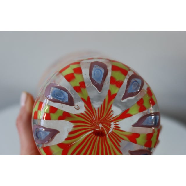 Hand-blown Murano glass vase featuring intricate murrine cane work in a vibrant palette of red, chartreuse yellow, and...