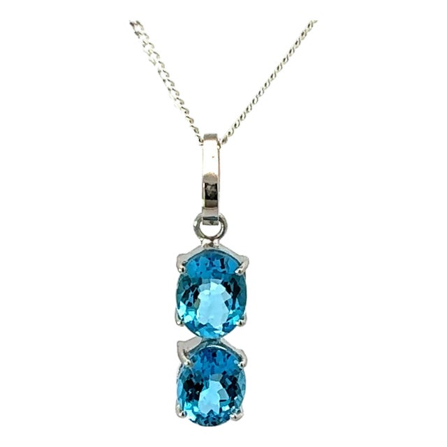 Elegant Blue Topaz 6.48 Carat Oval Cut Two Stone Silver Pendant For Sale