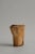 A sculptural ceramic vessel / pitcher with an asymmetrical, flared rim. Its faceted motif emerges through the firing...