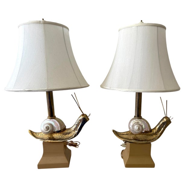 Pair of Italian table lamps. Brass snails with a real shell body. Brass antennae. Carved lacquered wood base. Original...