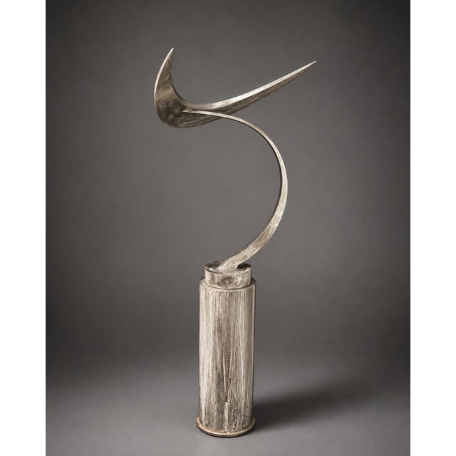 A 2 piece sculptural polished steel composition of celestial inspiration, designed with a sweeping crescent form rising...