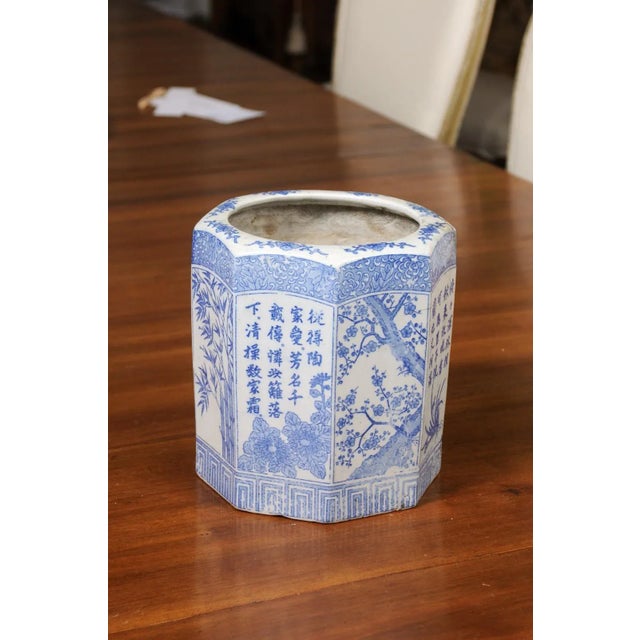 A Chinese blue and white hexagonal porcelain vase from the 20th century with hand-painted bamboo, flowers and calligraphy....