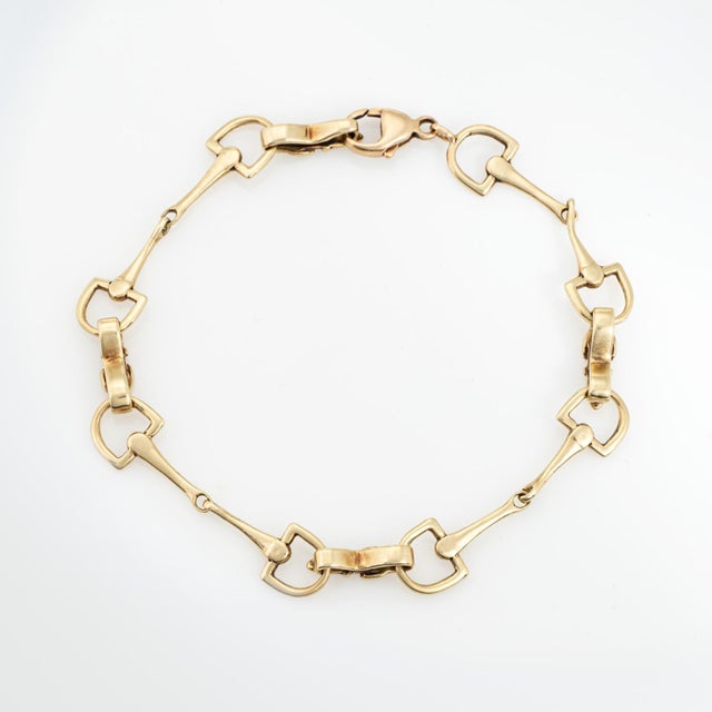 Stylish vintage Equestrian themed horse bit bracelet crafted in 14 karat yellow gold (circa 1960s to 1970s). The primary...