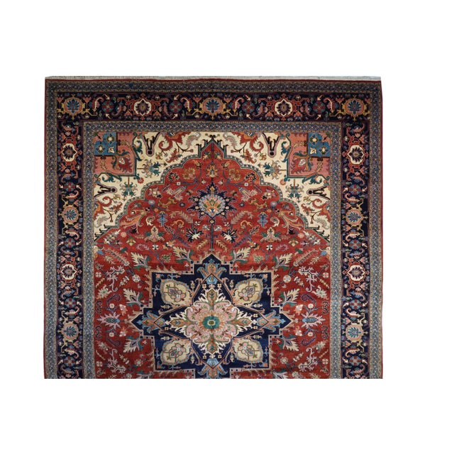 This rather well-drawn rustic carpet shows a scalloped red field cantered by a four palmettes, octogramme navy medallion...