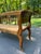 Beautiful early 19th century European bench crafted in solid elm with a handwoven rush seat. Features elegant rolled arms,...