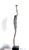 The last Fisherman: Slender and upright, the figure appears on the dark granite base like a creature between human and...