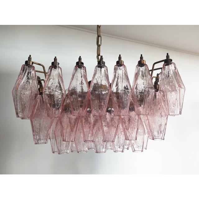 Elegant italian chandelier made from 56 beautiful murano pink glasses "poliedri". Structure in gold and brass colored...