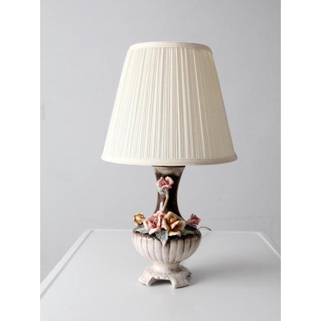 Mid-20th century Italian Capodimonte porcelain lamp with sculpted roses in soft pink and warm ivory tones set against a...