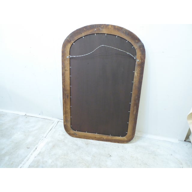 This curved corner whitewashed mirror has a gilt liner and measures 45.25"H x 23"W.