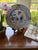 This pretty, hand-painted piece is the perfect size to anchor a collection of wall plates or add a bit of polish and color...