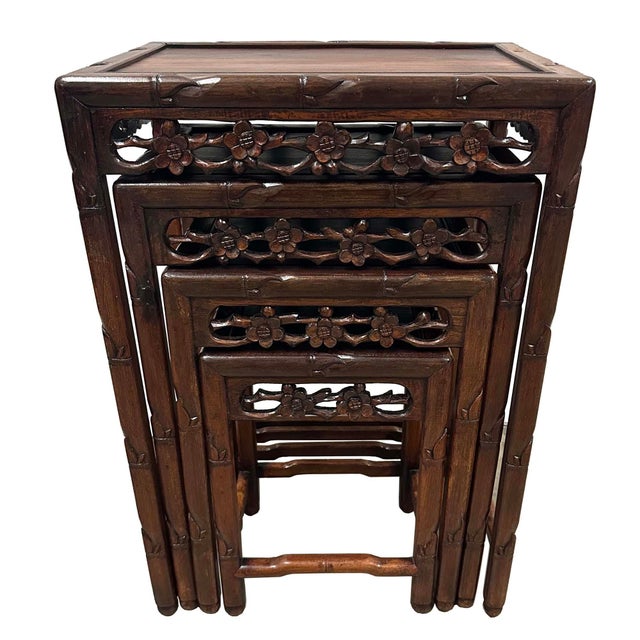This item is a set of antique Chinese nest of four nesting tables, crafted from fine dark hardwoods in about early 20th...