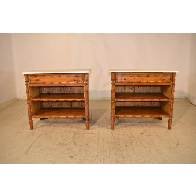 Pair of Vintage side tables with marble tops. The cases are made of vintage pine and have a single drawer over two...