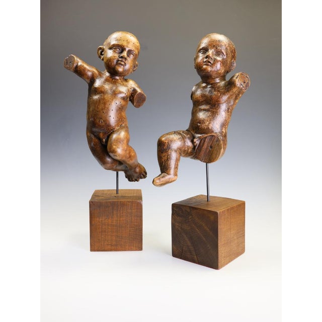 Pair of Austrian Baroque Limewood Putti / Cherubs, 18th Century A striking and highly decorative pair of 18th-century...