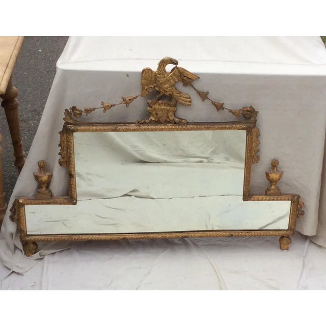 Unusual carved and giltwood eagle mirror with ornate details and swags. This is very old and it is fragile do to all the...