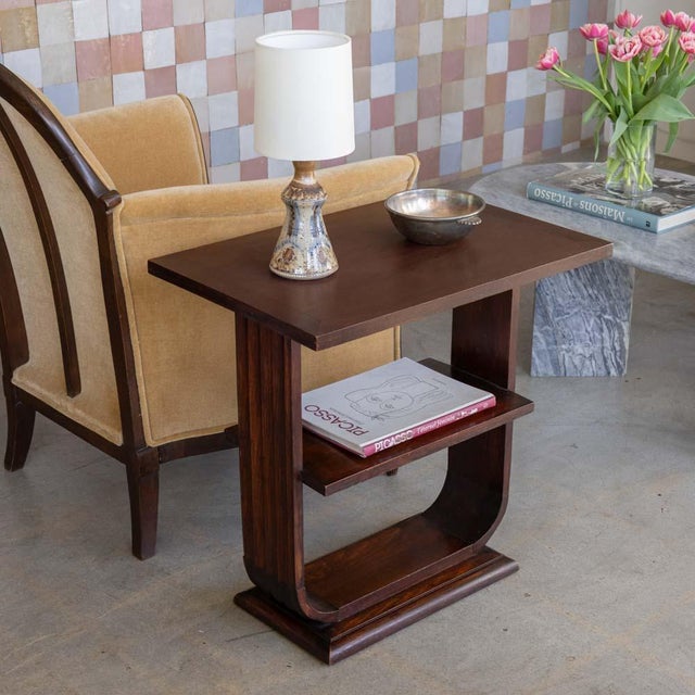 Incredible Art Deco two tier wood side table from France, 1930s. Rectangular top rests on a pedestal base with curved...