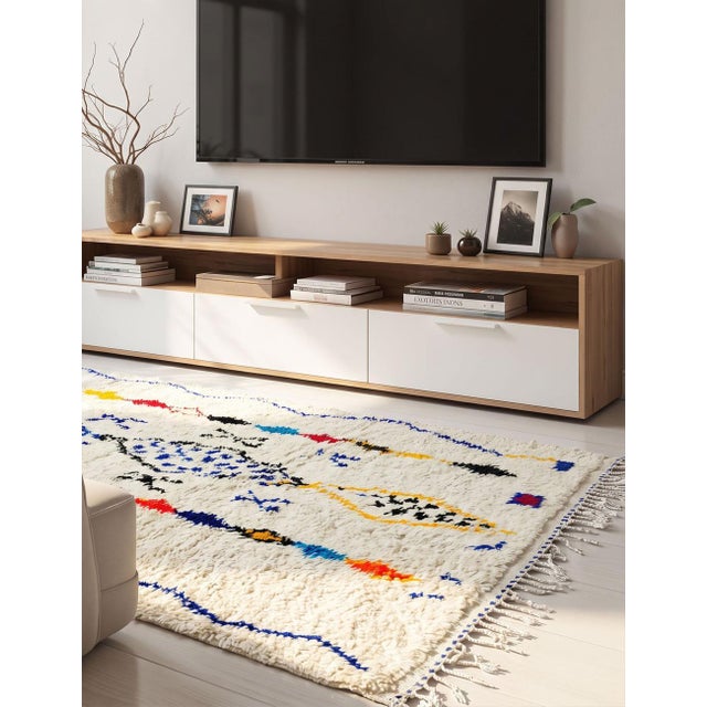 Azilal Moroccan Rug – Handmade Tribal Berber Wool Rug This handmade Azilal Moroccan rug features a soft ivory wool base...