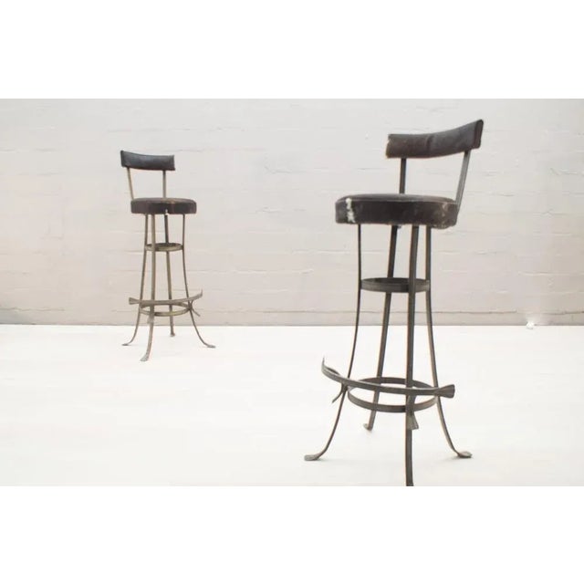 - Bar stools from the 1960s - With the original cowhide seat - Distance foot ring to seat: 51cm - Diameter seat: 35cm