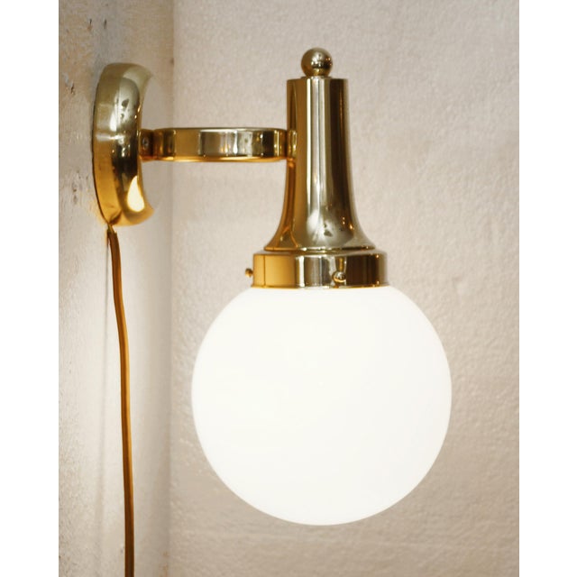 Art Deco Wall Lamp Art Deco wall lamp, produced in the 1920s/30s. Round wall plate, ring-shaped arm. White opal glass...