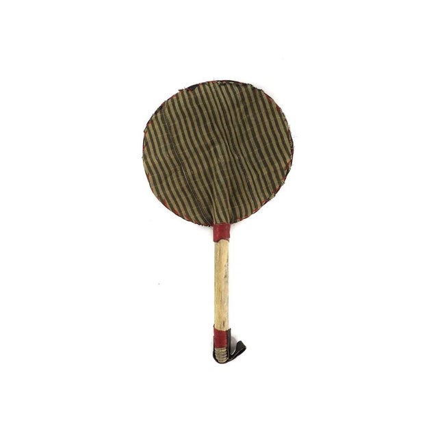 A beautiful beaded fan with colorful fabrics, cowrie shells and a wooden handle with a strap. In Yoruba culture, beads are...
