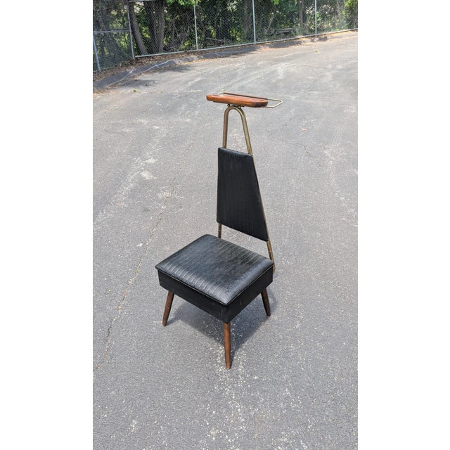 Elevate your bedroom or dressing area with this striking Mid-Century Modern valet butler chair by Nova Products. A...