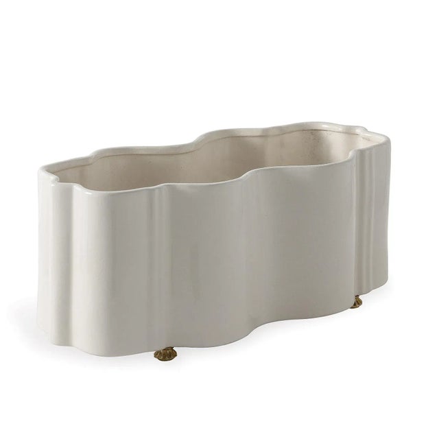The tuscan planter features scalloped curves cast into porcelain. The movement of the shape is fresh and bold. Accented...