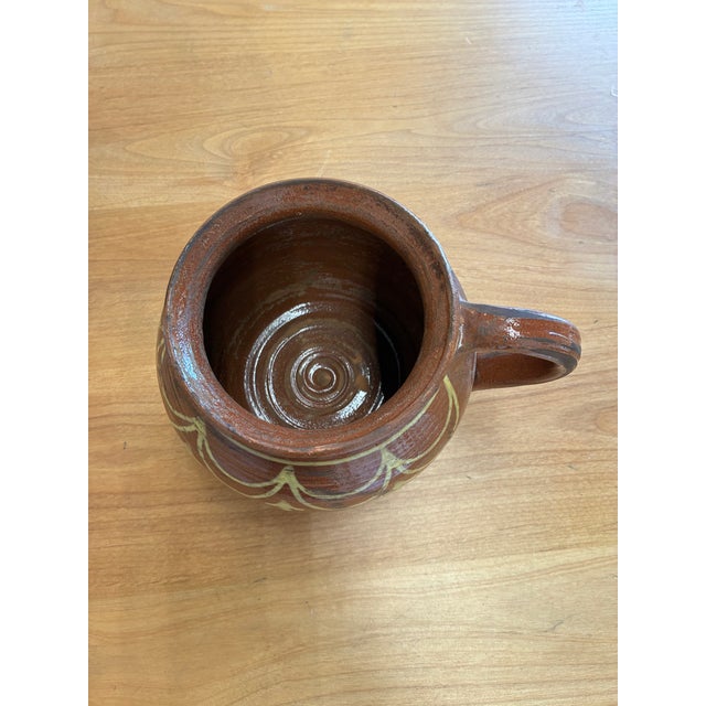 Rich in rustic character, this antique hand-thrown terracotta pot is a timeless decorative accent with enduring appeal....