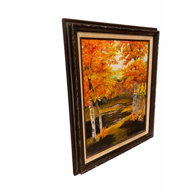 A richly colored woodland landscape featuring white-barked birch trees beside a winding creek, surrounded by golden...