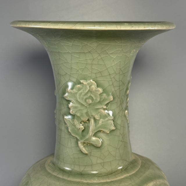 Beautiful antique Chinese Longquan celadon vase with embossed floral carvings. Natural crackle glaze, elegant flared‑mouth...