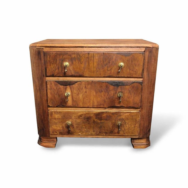 A beautifully proportioned art deco cc41 burr walnut chest of drawers, showcasing rich, expressive burr grain across the...