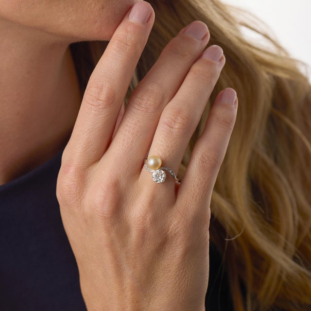 This romantic Edwardian Toi Et Moi engagement ring beautifully pairs an approximately 0.90 carat old European cut diamond...