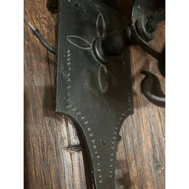 This matched pair of Spanish Revival wall sconces features hand-wrought iron construction with pierced Moorish-inspired...