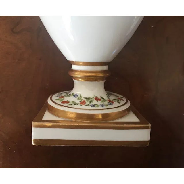 Pair antique 18th century old Paris porcelain urns and covers. Decorated with a band of pink roses on black ground and...