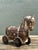 This exquisite hand-carved wooden Trojan horse serves as both a captivating sculpture and a functional decorative box....