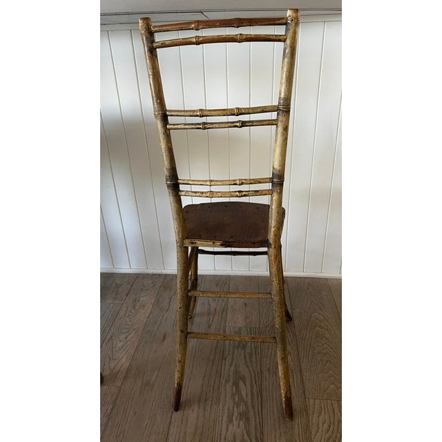 Faux-Bamboo Wood Side Chair C 1870 - 1900. Turned faux-bamboo frame, tall narrow back, shaped plank seat, splayed legs and...