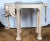 Marge Carson elephant rolling bar cart or table. Made of composition wood with a tinted glass top and brass rails.