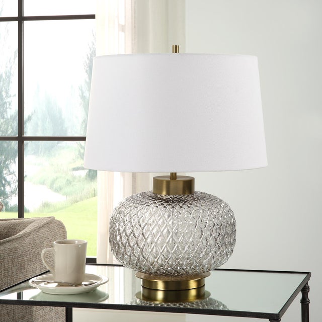 The Estelle Table Lamp Features A Heavily Embossed, Round Lattice Inspired, Light Smoke-gray Glass Base Accented By A...