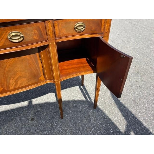 The Mahogany Federal Style Hickory Chair Sideboard is a beautifully crafted piece of furniture with a rich brown color and...