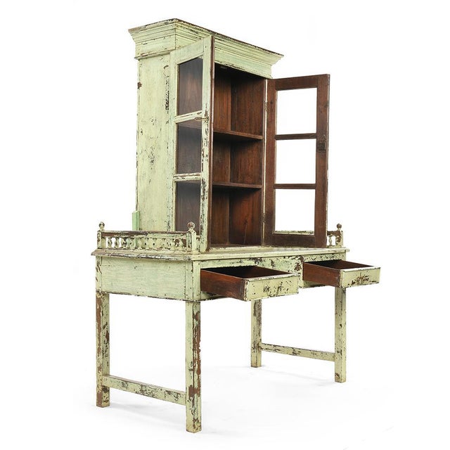 Glass cabinet with shelf and 2 drawers in patinated wood. This piece is designed in the style of the selected designer...