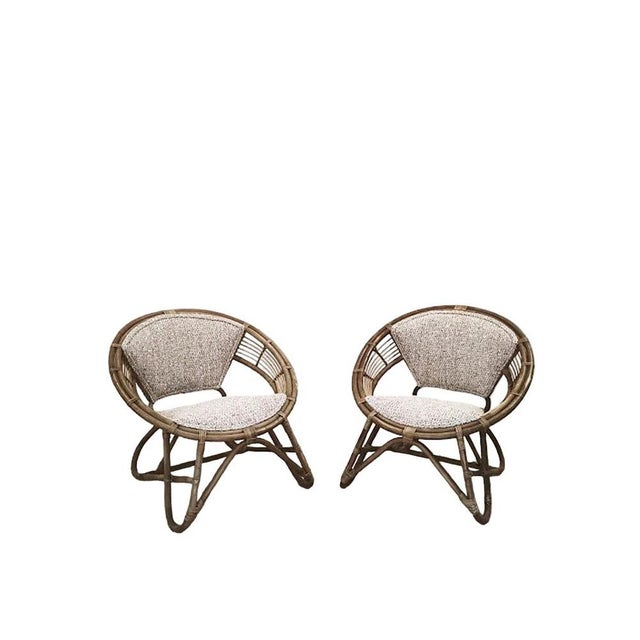 Exceptional matching pair of handcrafted rattan lounge chairs produced by Imaeda Shoten, Japan, retaining their original...