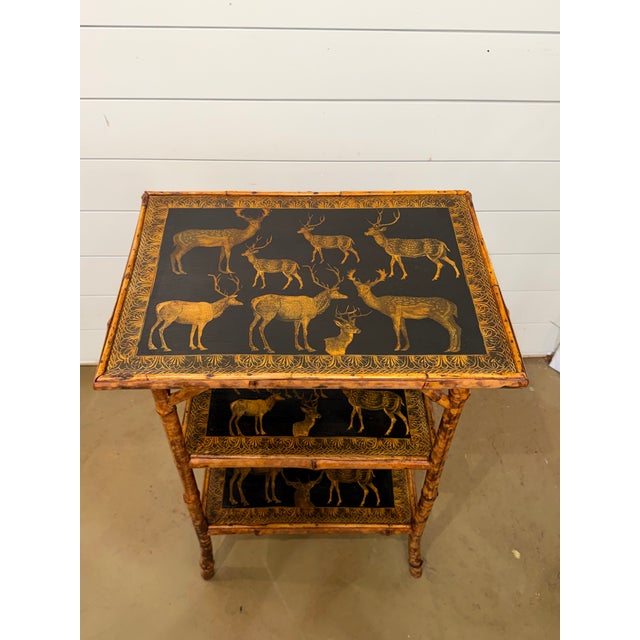 This 19th Century English Bamboo Side table features a delightful variety of elk decoupaged onto the top and 2 lower...