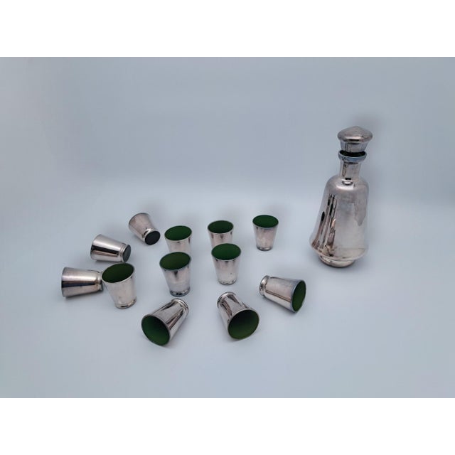 Add a touch of luxury and sophistication to your home with this rosolio set, consisting of a decanter and twelve shot...