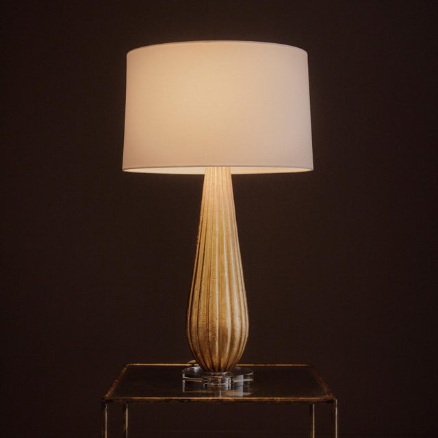 The Claire Table Lamp brings a sense of quiet glamour through texture, light, and refined proportion. Its elongated...