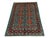 A vivid turquoise field brings this wool rug’s repeating geometric Tree of Life design into focus. Red medallions,...