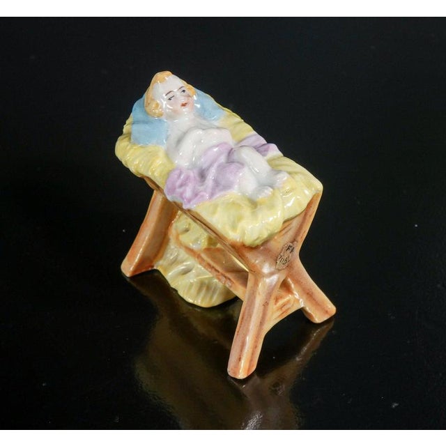 Hand-painted porcelain nativity scene by kister, composed of baby jesus, mary, joseph, donkey, ox and angels. Germany,...