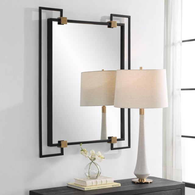 This Mirror Pairs Contemporary Styling With Industrial Details Featuring A Black Iron Frame Accented By Lightly Antiqued...