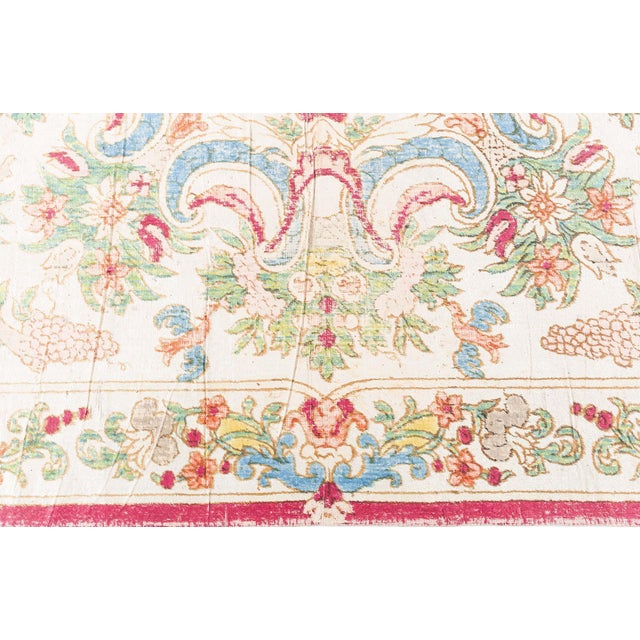 This magnificent silk table carpet, dating to the 1800s, is a rare example of European textile artistry designed not for...