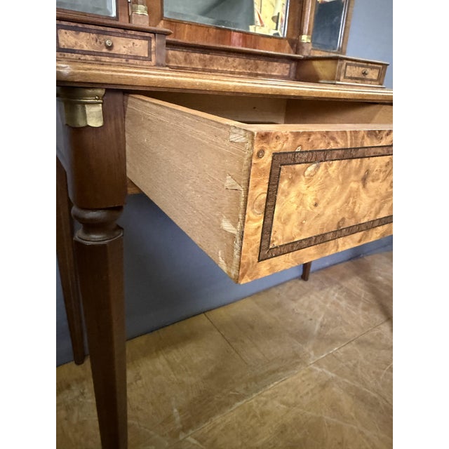 Art Deco dressing table, circa 1925, veneered in mahogany and burr walnut. It features two drawers beneath the frieze and...
